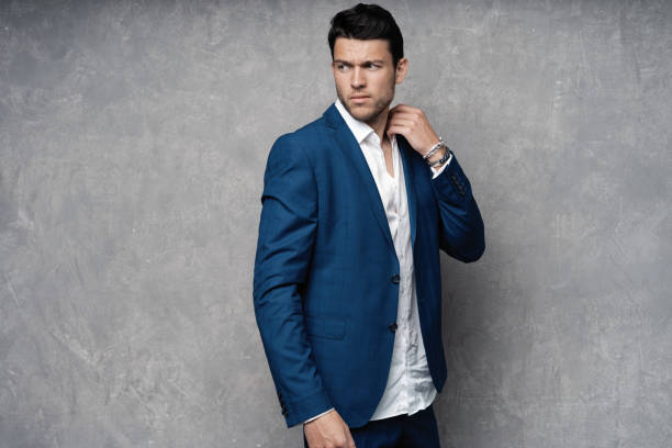 istock Handsome man wear blue suit isolated on grey background. 1280348181