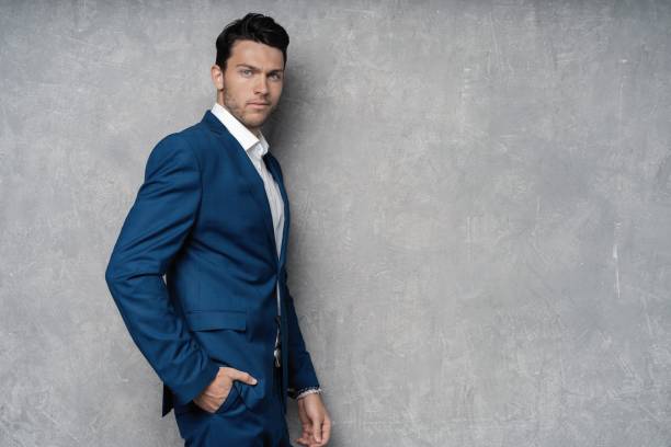 istock Handsome man wear blue suit isolated on grey background. 1280348190