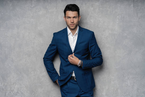 istock Handsome man wear blue suit isolated on grey background. 1280348192