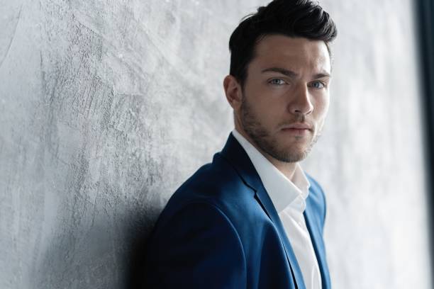 istock Handsome man wear blue suit isolated on grey background. 1280348195