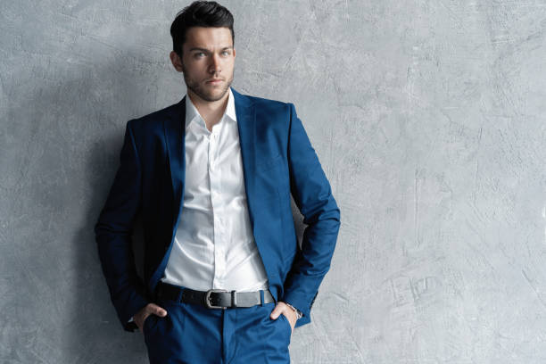 istock Handsome man wear blue suit isolated on grey background. 1280348198