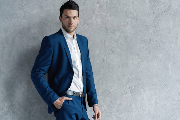 istock Handsome man wear blue suit isolated on grey background. 1280348210