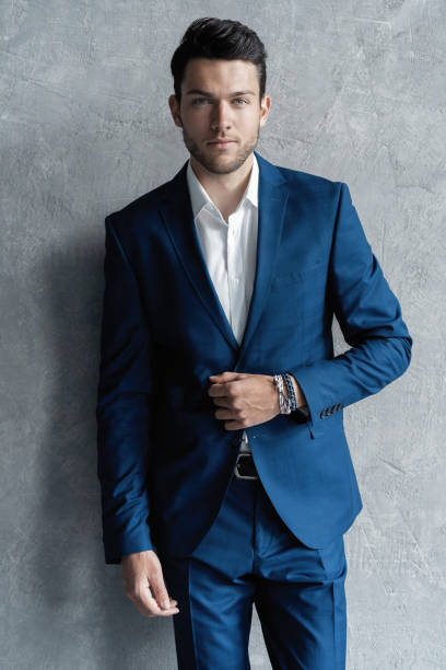 istock Handsome man wear blue suit isolated on grey background. 1280348226