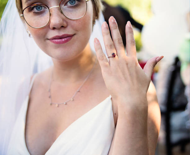 istock Millennial bride showing ring at wedding cocktail in backyard. 1280348348