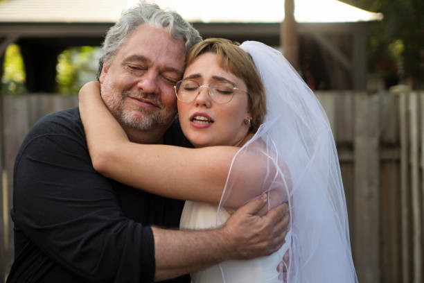 istock Millennial bride posing with father at wedding cocktail in backyard. 1280348698