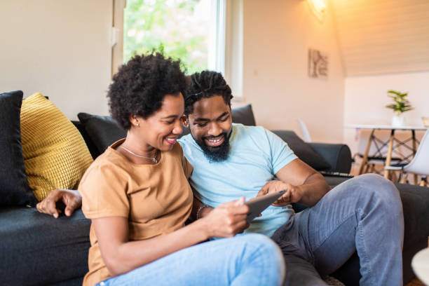 istock Happy African American couple using digital tablet. 1280349013