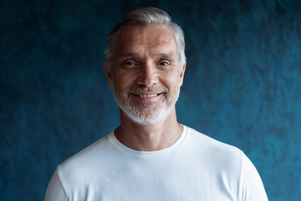 istock Casual Grey-haired Mature handsome man portrait over dark blue wall background. 1280349160