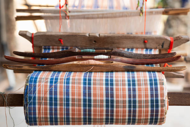 istock Shuttle weaving tool on the antique loom and thread, traditional Thai weaving machine 1280349820
