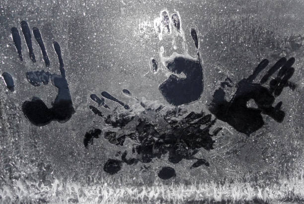 Photo of Handprints on frozen car window in Norway.