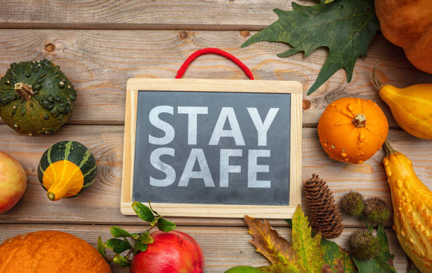 Stay safe message and thanksgiving pumpkins against wooden background. COVID 19 days Thanksgiving COVID 19 days. STAY SAFE message  and thanksgiving flatlay on wooden background. Coronavirus protection thanksgiving holiday covid stock pictures, royalty-free photos & images