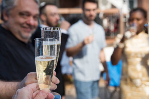istock Celebratory toast at wedding cocktail in backyard. 1280351965