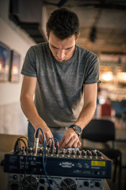 istock Behind the scene. Sound technician electric engineer adjusting sound elements 1280354630