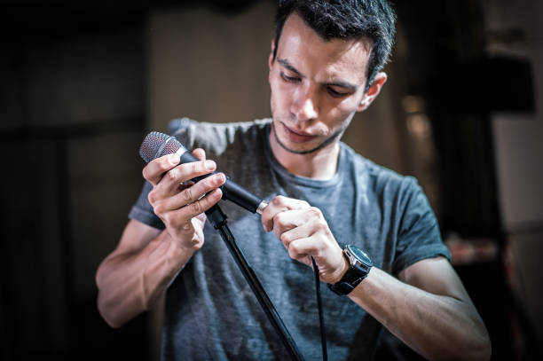 istock Theater audio technician adjusting an microphones on the scene 1280354691