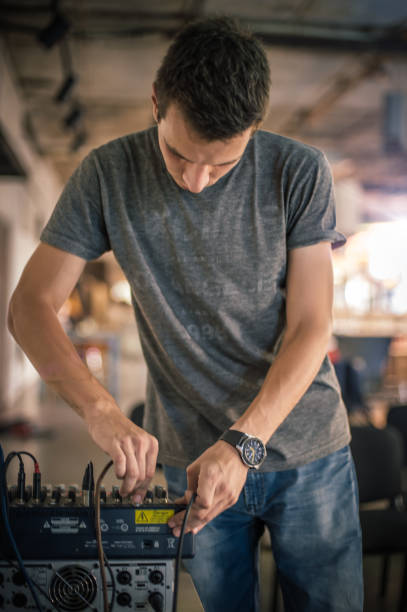 istock Behind the scene. Sound technician electric engineer adjusting sound elements 1280355033
