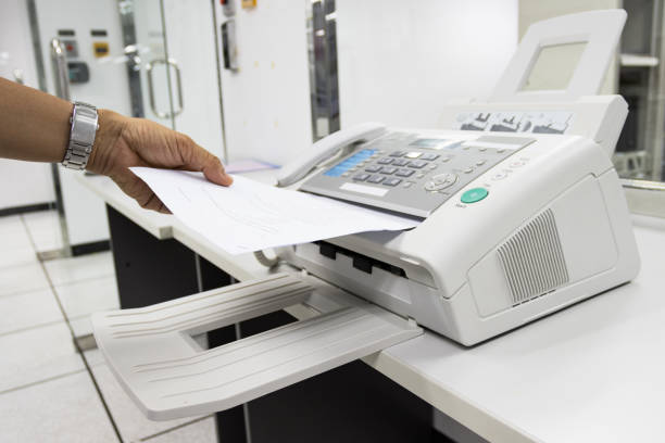 istock hand man are using a fax machine in the office, equipment for data transmission. 1280355222