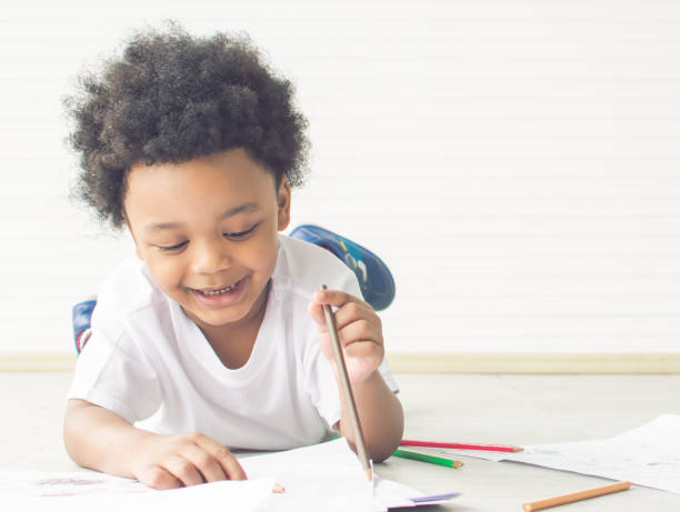 istock Little african boy is drawing and painting 1280355469