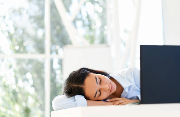 istock Tired businesswoman sleeping on the workplace on office desk 1280357009