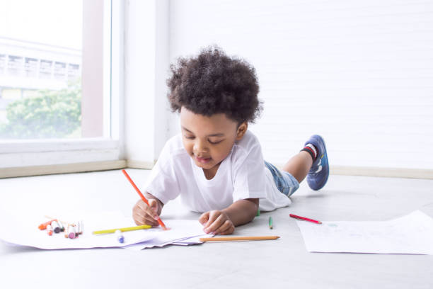 istock Little african boy is drawing and painting 1280357983