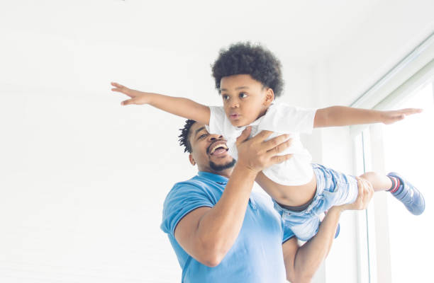istock African father is playing with his son 1280359163