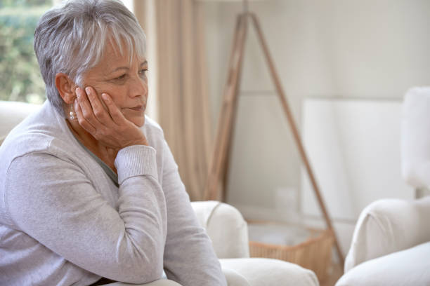 istock Senior woman suffering from headache at home 1280359171
