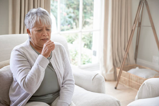 istock Sick coughing senior woman 1280359178