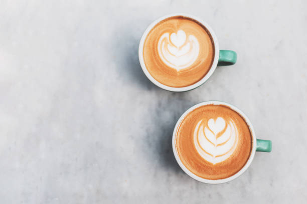 istock Two beautiful cups of cappuccino on the table. 1280359276