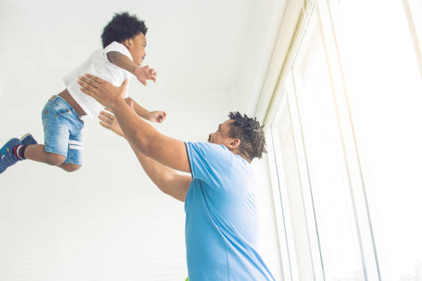 istock African father is playing with his son 1280360266