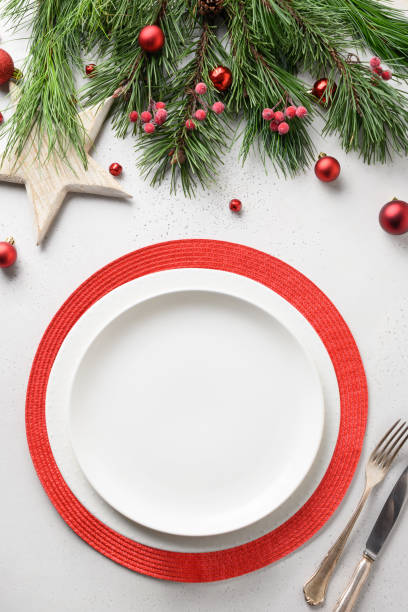 istock Christmas festive table setting with white and red holiday elegant decorations on white. 1280360354