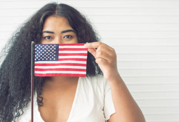 istock African woman holding american flag 1280360475