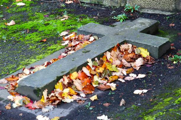 istock Stone Cross and Autumn Leaves 1280360674