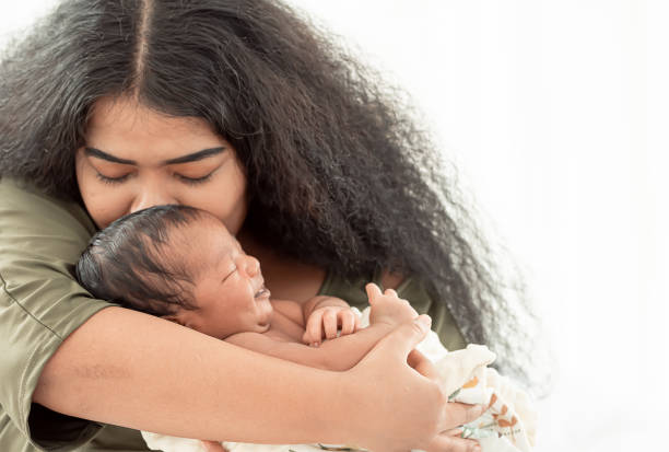 istock mom kissing her baby 1280361931