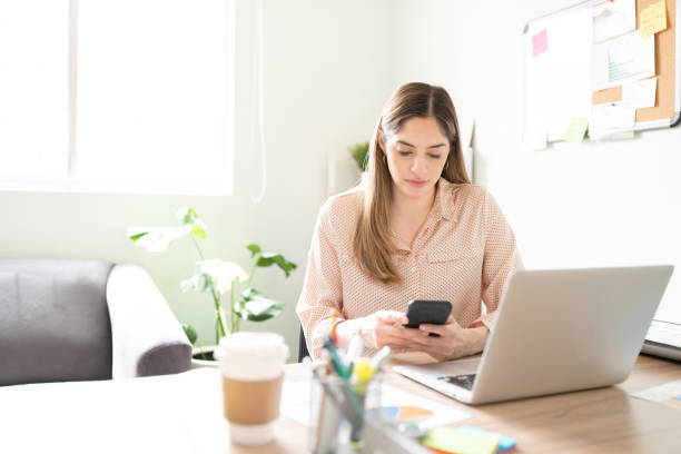 istock Businesswoman using a smartphone in an office 1280362654