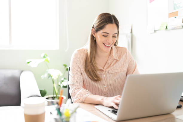 istock Businesswoman looking happy using a laptop 1280362662