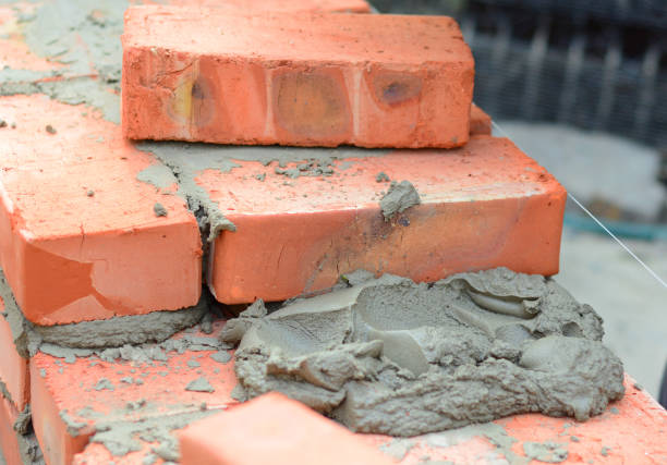istock A close-up on building a brick wall, the process of bricklaying using mortar, cement and mason line. 1280362812
