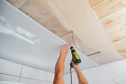 electrician installing downlights