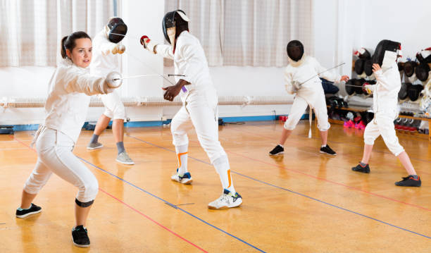 istock Young woman fencer practicing effective fencing techniques in training room 1280363937