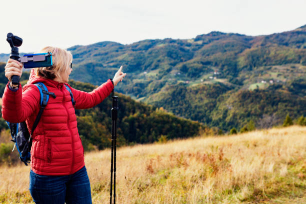 istock Happy backpacker hiking and vlogging 1280364787