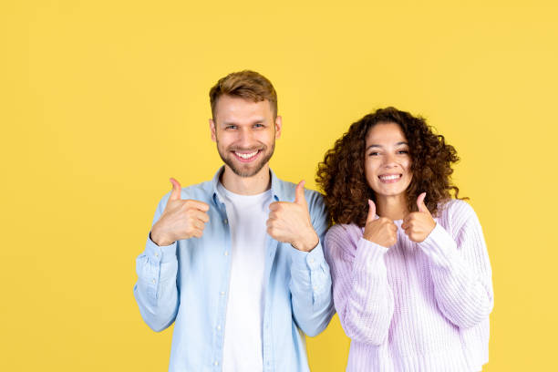 istock Two mixed race people on yellow background 1280364827