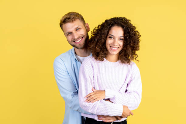 istock Two mixed race people on yellow background 1280364853