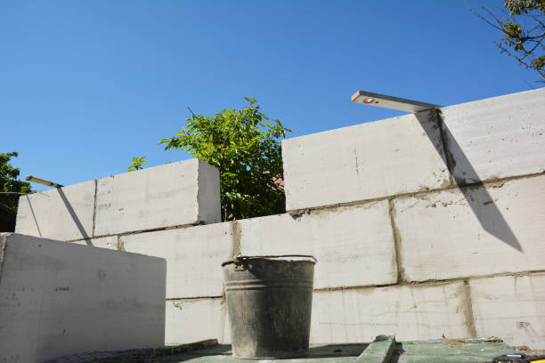 istock A close-up on home addition construction from autoclaved aerated concrete blocks using a trowel, mortar in a bucket and spirit level. 1280365095