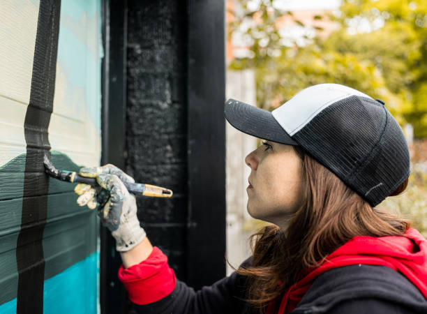 istock Female mural artist at work 1280365937