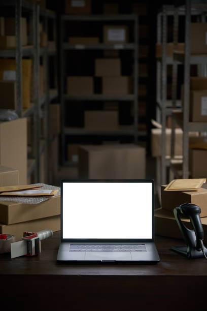 istock Online ecommerce store mockup, dropshipping business website concept. Table with laptop computer mock up blank white screen and shipping boxes, retail marketplace, warehouse delivery background. 1280366040