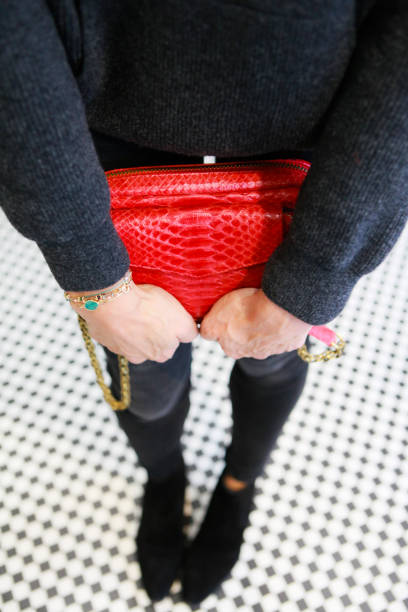 istock Close-up on a red leather bag in a woman's hands 1280366213