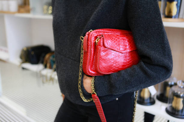 istock Close-up on a red leather bag in a woman's hands 1280366231