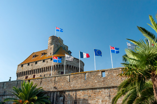 Saint Malo, France - October 31, 2014: Flags flying over the fortification wall in Saint Malo, Brittany, France