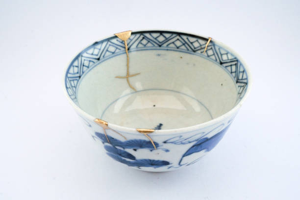 istock Kintsugi bowl Antique broken Japanese pottery repaired with gold. 1280370208