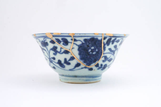 istock Kintsugi bowl Antique broken Japanese pottery repaired with gold. 1280370237