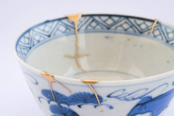 istock Kintsugi bowl Antique broken Japanese pottery repaired with gold. 1280370245