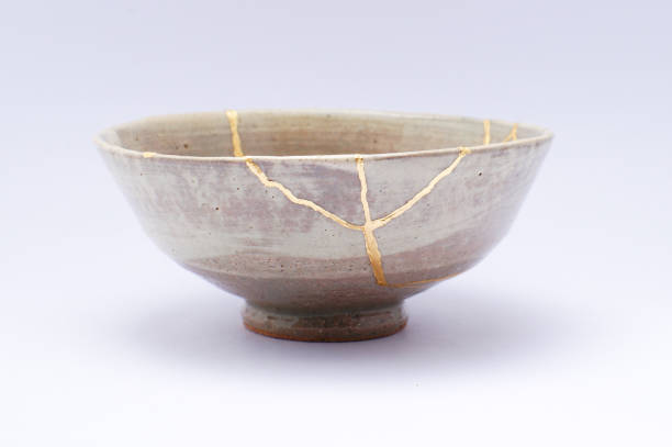 Kintsugi Antique broken Japanese bowl repaired with gold. stock photo