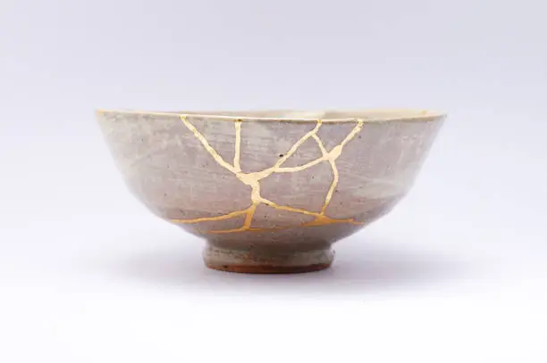 Photo of Kintsugi Antique broken Japanese bowl repaired with gold.